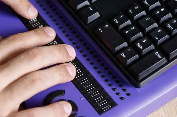 Blind person using computer with braille keyboard
